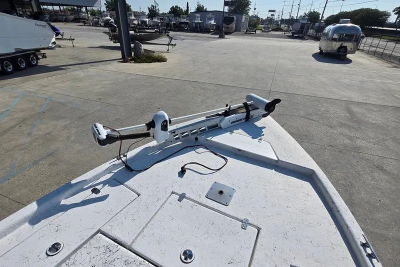 Slide: The Image of 2014 Blazer Bay 2170 boat with trolling motor in a parking lot. - 14
