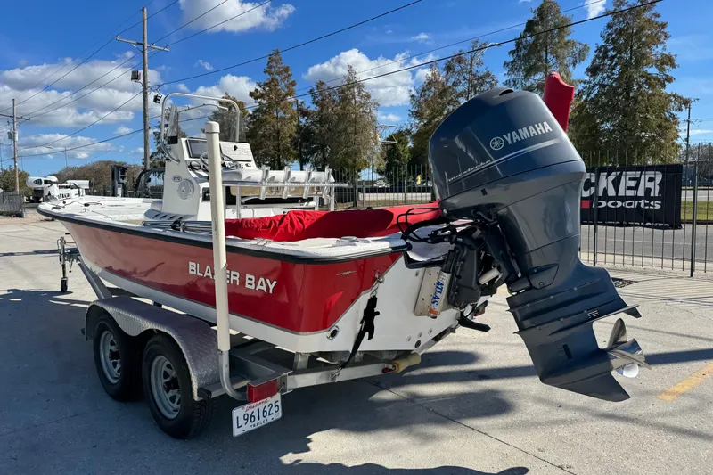Slide: The Image of 2014 Blazer Bay 2170 boat with Yamaha motor on trailer, parked outdoors. - 3