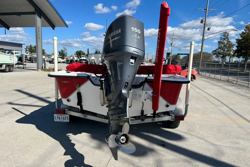 Slide: The Image of 2014 Blazer Bay 2170 boat with Yamaha 150 engine, parked outdoors. - 4