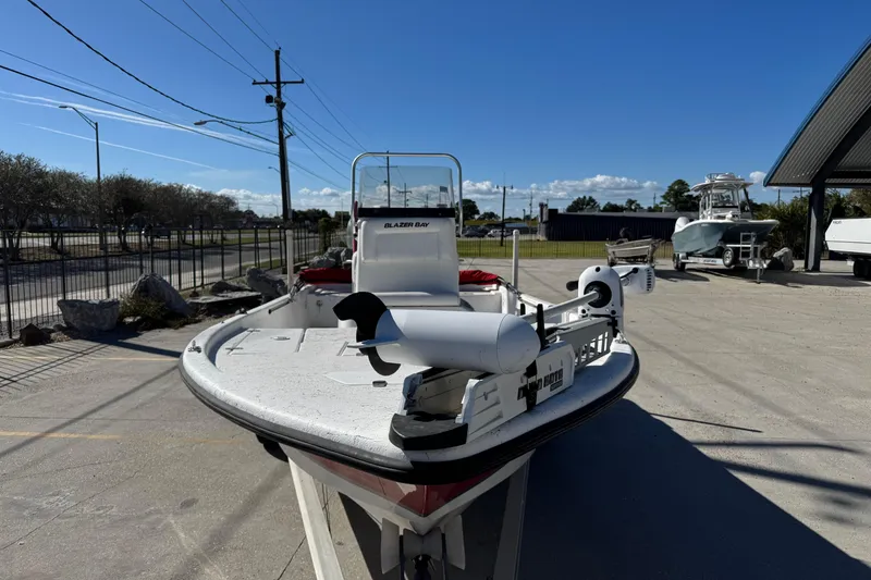 Slide: The Image of 2014 Blazer Bay 2170 boat parked outdoors under clear blue sky. - 7