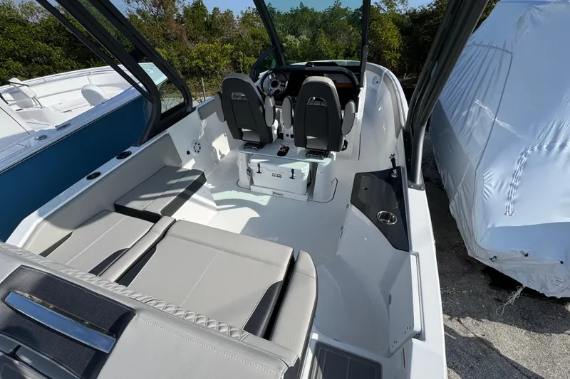 Slide: The Image of 2026 Monterey Elite 25 OB boat interior with seating and steering area. - 3