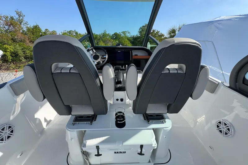 Slide: The Image of 2026 Monterey Elite 25 OB boat interior with dual seats and modern dashboard. - 5