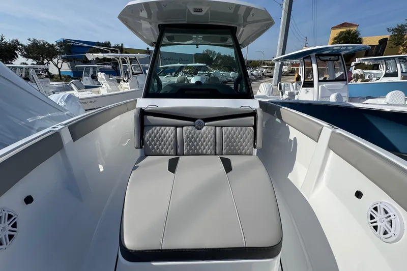 Slide: The Image of 2026 Monterey Elite 25 OB boat interior with cushioned seating and modern design. - 9