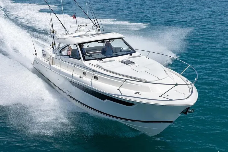 Slide: The Image of Manufacturer Provided Image: 2025 Pursuit OS 405 Offshore boat cruising on clear blue water. - 2