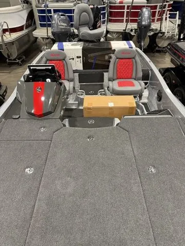 Slide: The Image of 2026 Ikon Boats LXE20 with red and gray seating, displayed in a showroom. - 15