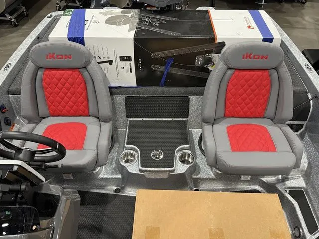 Slide: The Image of 2026 Ikon Boats LXE20 interior with red and gray seats, steering wheel, and console. - 17