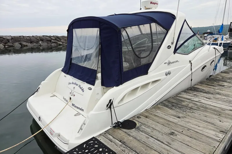 The Image of 2007 Sea Ray 290 Sundancer docked, featuring blue canopy and sleek design. - 1