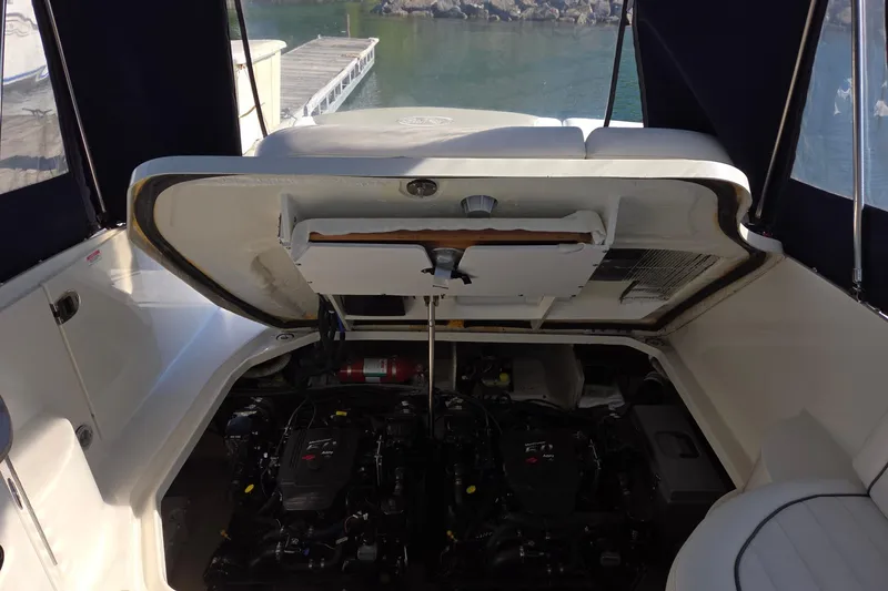 Slide: The Image of 2007 Sea Ray 290 Sundancer engine compartment with open hatch, dockside view. - 11