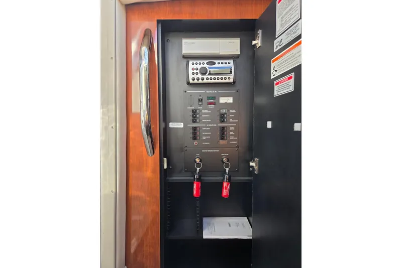 Slide: The Image of Electrical panel inside 2007 Sea Ray 290 Sundancer boat, featuring control switches and stereo system. - 14