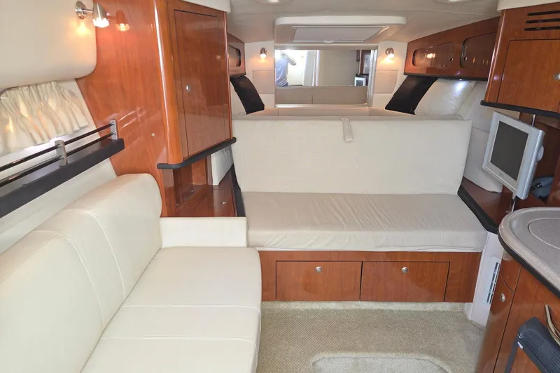 Slide: The Image of Interior of 2007 Sea Ray 290 Sundancer with elegant wood finish and cozy seating. - 15