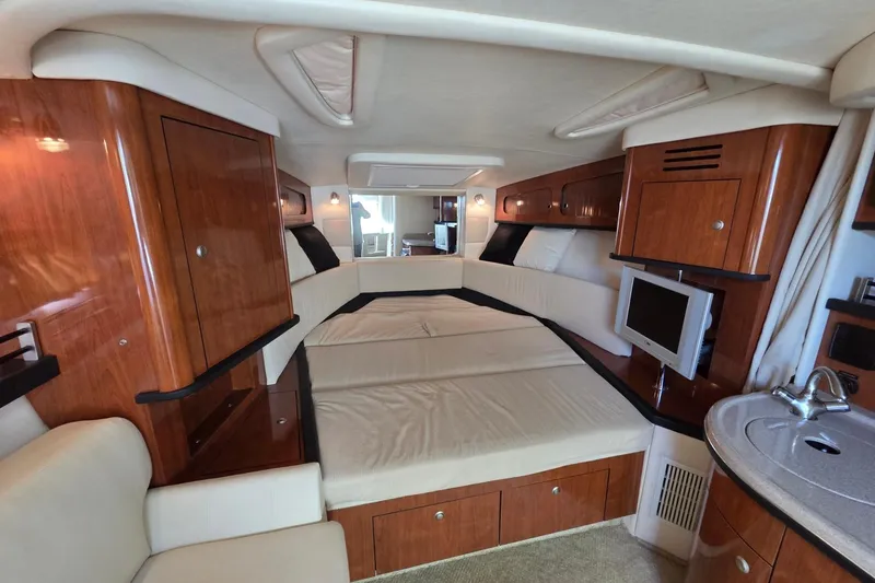 Slide: The Image of Luxurious interior of 2007 Sea Ray 290 Sundancer yacht with wood cabinetry and cozy seating. - 17