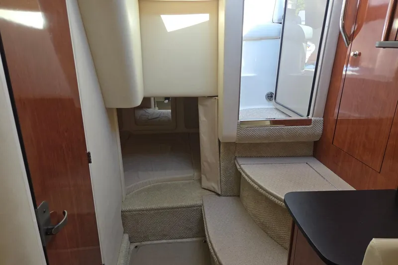 Slide: The Image of Interior of 2007 Sea Ray 290 Sundancer, featuring stairs and cabin entrance. - 19