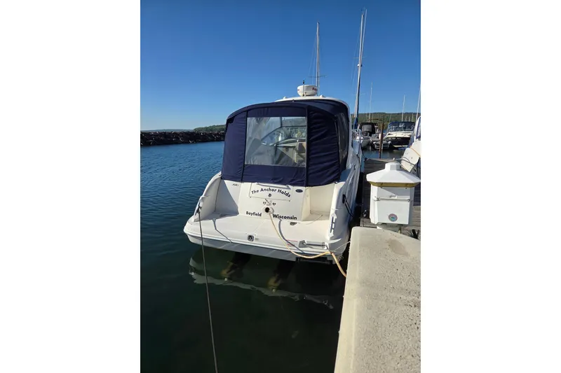 Slide: The Image of 2007 Sea Ray 290 Sundancer docked at a marina under clear blue skies. - 2
