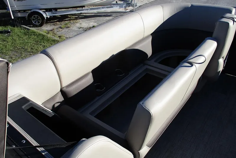 Slide: The Image of 2026 Bentley Pontoons Legacy 243 Swingback interior with beige seating and cup holders. - 11