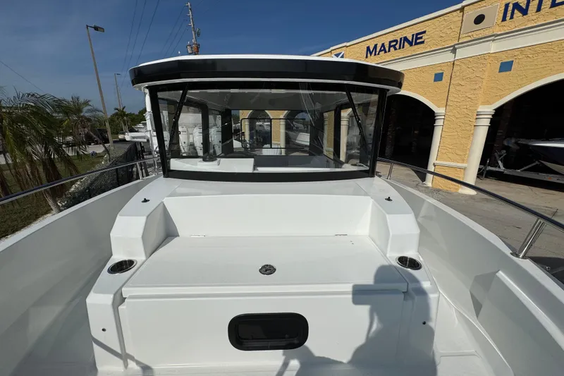 Slide: The Image of 2026 Jeanneau NC Sport 795 Series 2 boat at a marina, front view. - 11