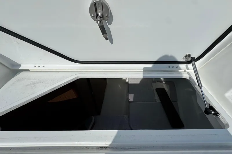 Slide: The Image of Open storage compartment on 2026 Jeanneau NC Sport 795 Series 2 boat. - 12