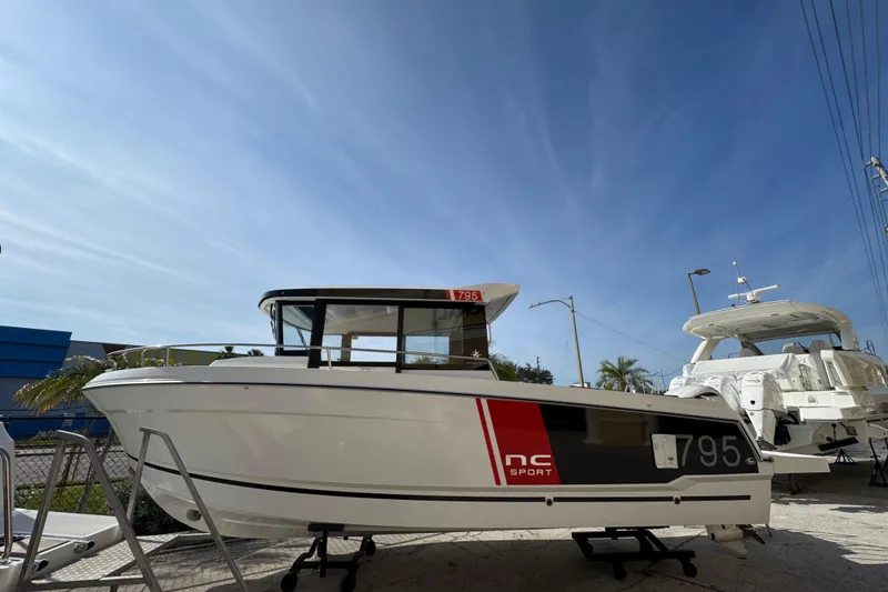 Slide: The Image of 2026 Jeanneau NC Sport 795 Series 2 boat displayed outdoors under clear sky. - 2