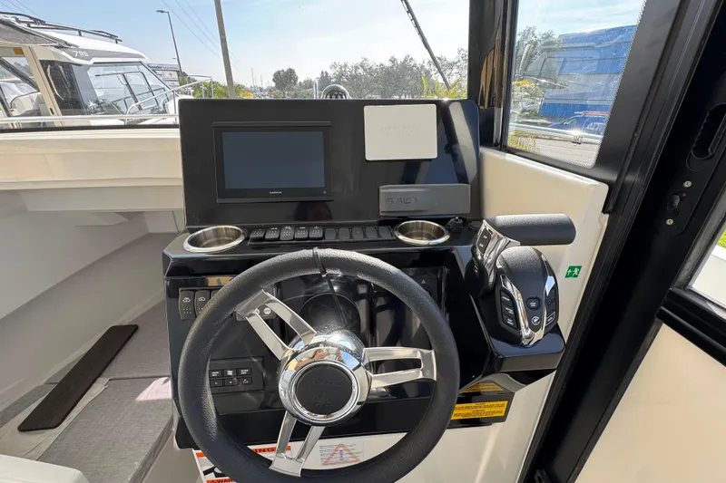 Slide: The Image of 2026 Jeanneau NC Sport 795 Series 2 helm with steering wheel and control panel. - 22