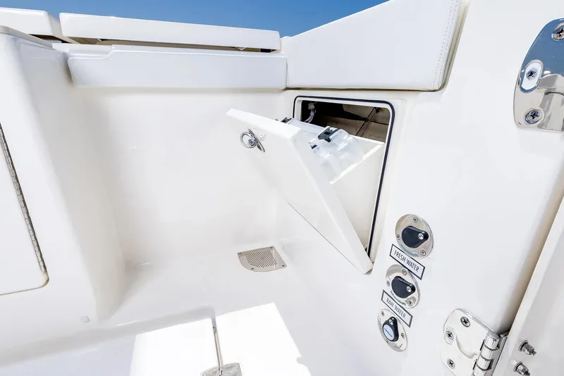 Slide: The Image of Manufacturer Provided Image: 2025 Pursuit OS 445 Offshore boat compartment with fresh and raw water controls. - 17