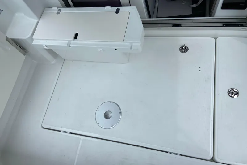 Slide: The Image of The image shows the deck of a Jeanneau NC 795 Series 2 with storage and covers. - 10