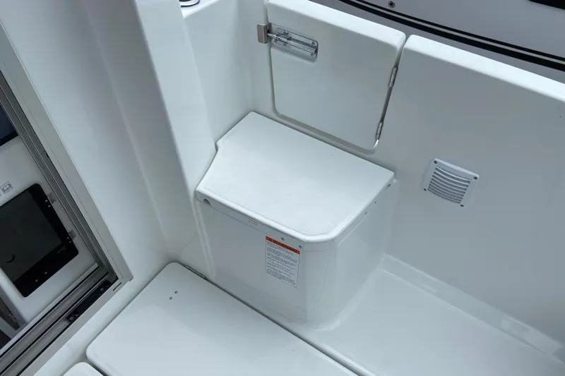 Slide: The Image of 2026 Jeanneau NC 795 Series 2 boat interior, featuring a white storage compartment and seating area. - 12