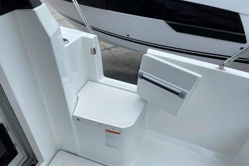 Slide: The Image of 2026 Jeanneau NC 795 Series 2 boat interior with white seating and storage compartment. - 14
