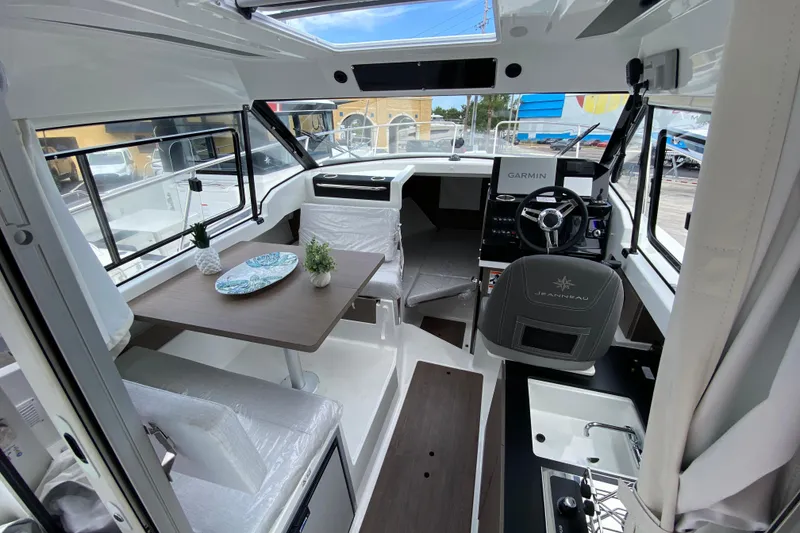 Slide: The Image of Interior of 2026 Jeanneau NC 795 Series 2 boat with modern helm and dining area. - 17