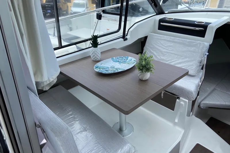 Slide: The Image of Interior of 2026 Jeanneau NC 795 Series 2 boat with dining table and seating. - 18