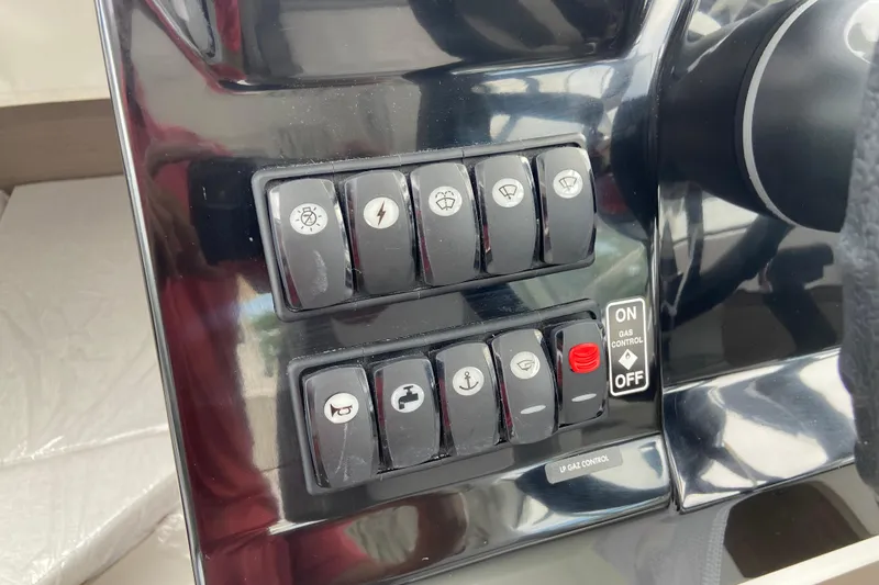 Slide: The Image of Control panel of 2026 Jeanneau NC 795 Series 2 boat with labeled switches. - 24