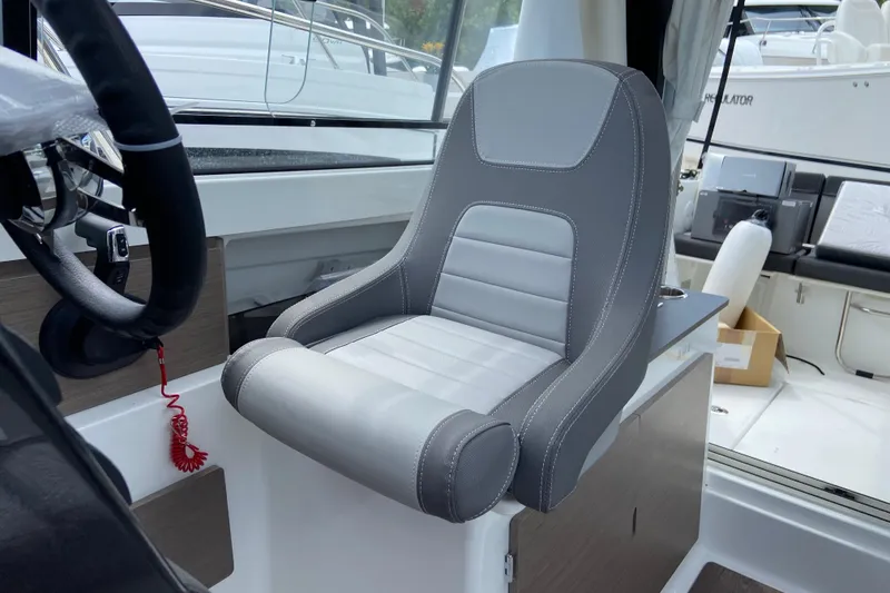Slide: The Image of Captain's seat in 2026 Jeanneau NC 795 Series 2 boat, featuring sleek design and modern controls. - 30