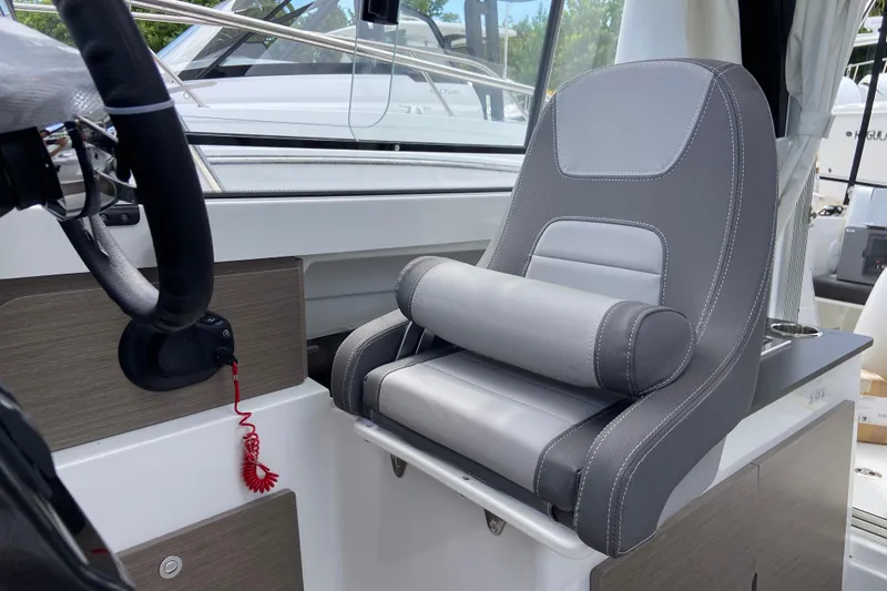 Slide: The Image of Steering area of 2026 Jeanneau NC 795 Series 2 boat with modern seating. - 31