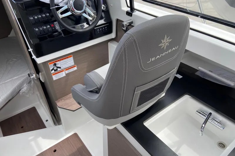Slide: The Image of Interior of 2026 Jeanneau NC 795 Series 2 boat with steering wheel and sink. - 32