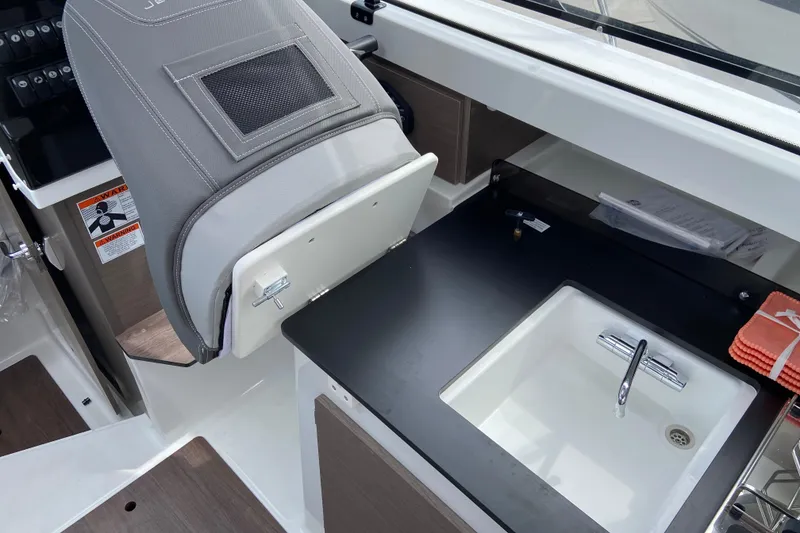 Slide: The Image of 2026 Jeanneau NC 795 Series 2 interior with sink and seating area. - 33