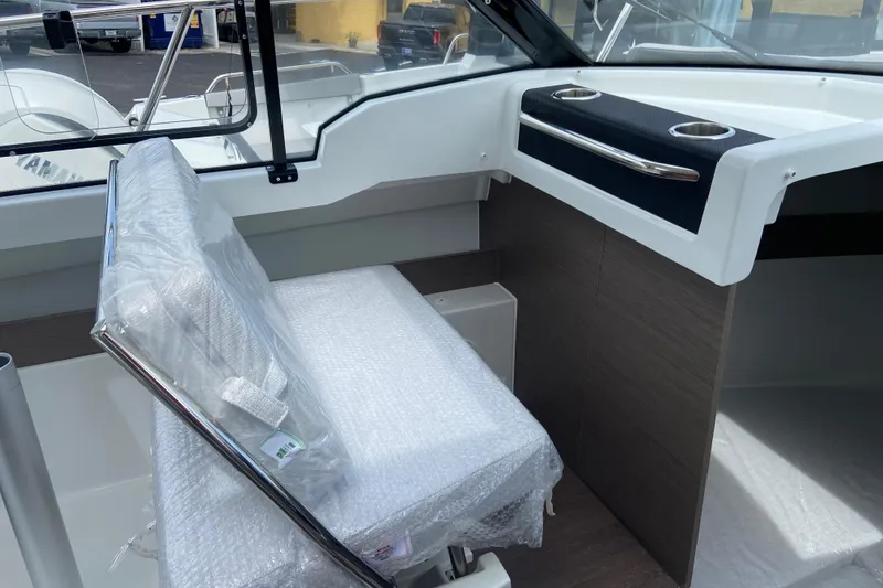 Slide: The Image of Interior of 2026 Jeanneau NC 795 Series 2 boat, featuring a wrapped seat and dashboard. - 34