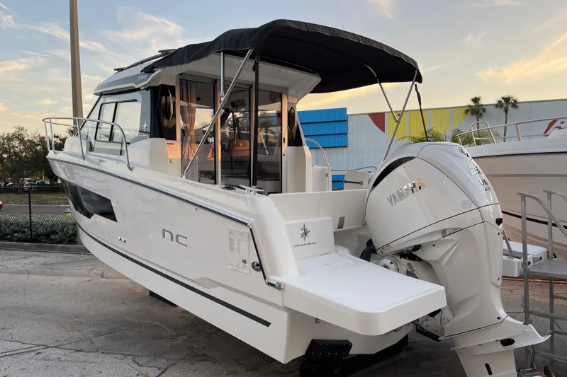 Slide: The Image of 2026 Jeanneau NC 795 Series 2 boat with Yamaha outboard motor, docked at sunset. - 4