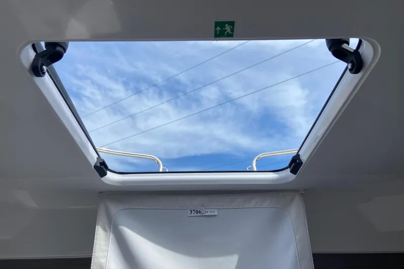 Slide: The Image of Skylight view from Jeanneau NC 795 Series 2, 2026 model, showcasing blue sky and clouds. - 45