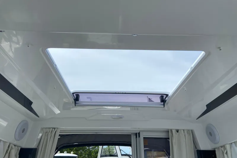 Slide: The Image of Interior view of 2026 Jeanneau NC 795 Series 2 boat with open skylight. - 48
