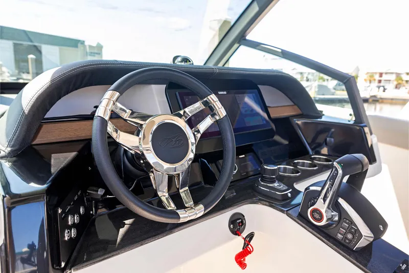 Slide: The Image of Steering console of 2026 Monterey Elite 30 OB boat with modern controls and touchscreen display. - 20