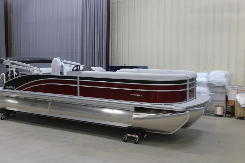 The Image of 2026 Harris Cruiser 250 pontoon boat in a warehouse setting. - 1