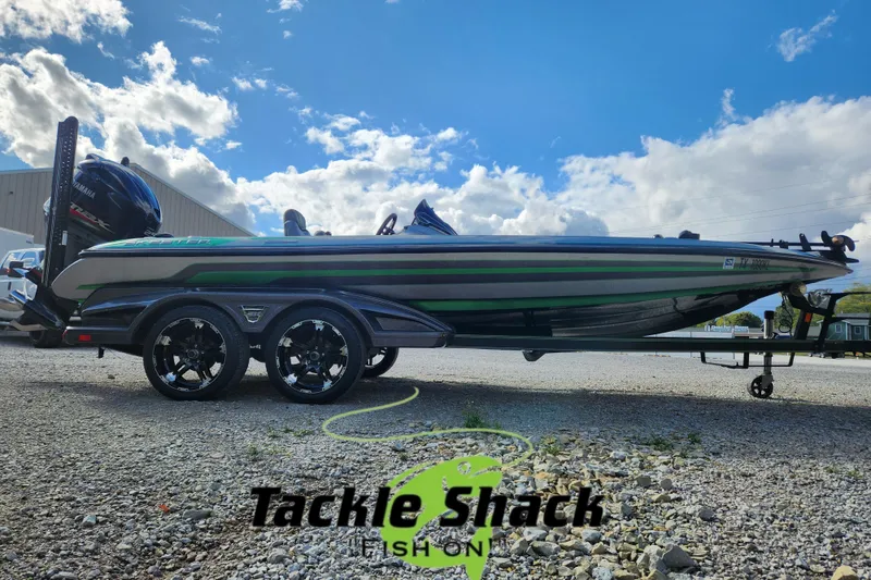 Slide: The Image of 2019 Skeeter FX21 boat on trailer under blue sky, Tackle Shack logo visible. - 1