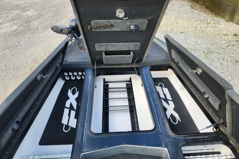 Slide: The Image of 2019 Skeeter FX21 boat storage compartments open, showcasing interior layout and organization. - 20