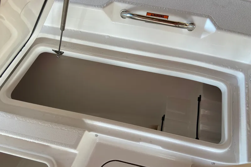 Slide: The Image of Storage compartment of 2026 Sportsman Masters 267 Bay Boat, featuring a sleek white interior. - 17
