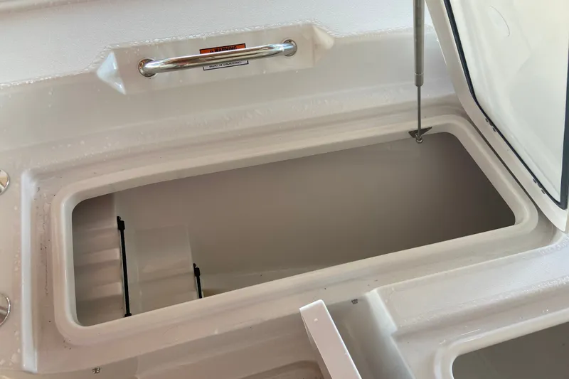 Slide: The Image of Open storage compartment on 2026 Sportsman Masters 267 Bay Boat, featuring hydraulic lift support. - 15