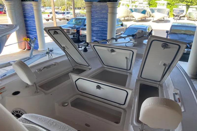 Slide: The Image of 2026 Sportsman Masters 267 Bay Boat with open storage compartments and seating. - 14