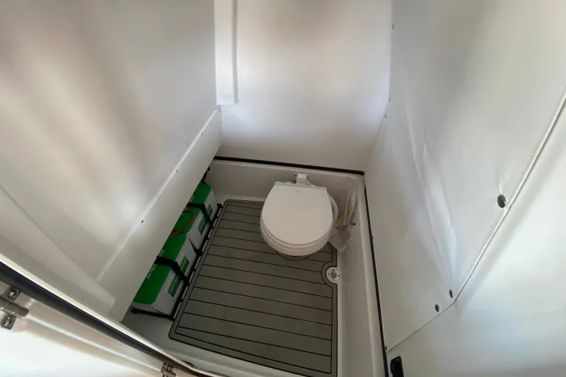 Slide: The Image of Interior of 2026 Sportsman Masters 267 Bay Boat featuring a compact marine toilet. - 24