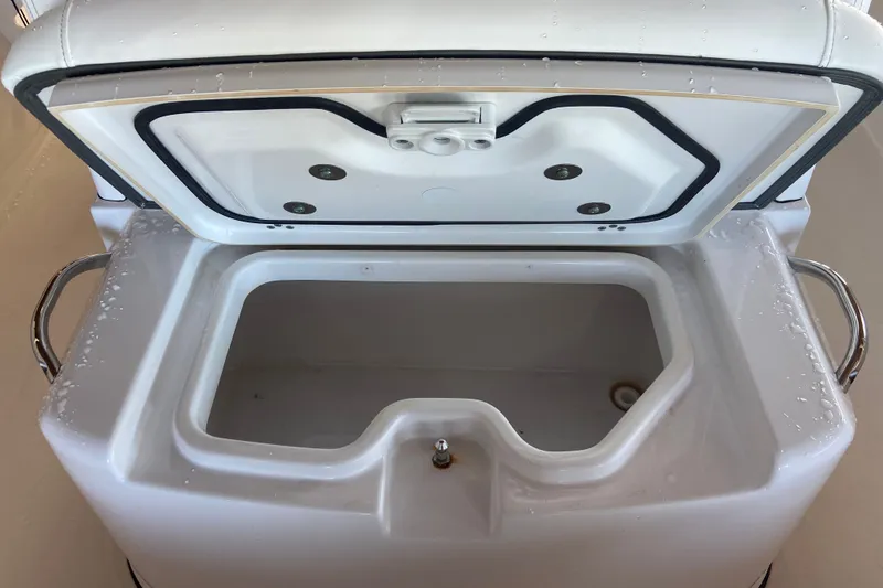Slide: The Image of Open storage compartment on 2026 Sportsman Masters 267 Bay Boat, featuring stainless steel handles. - 22