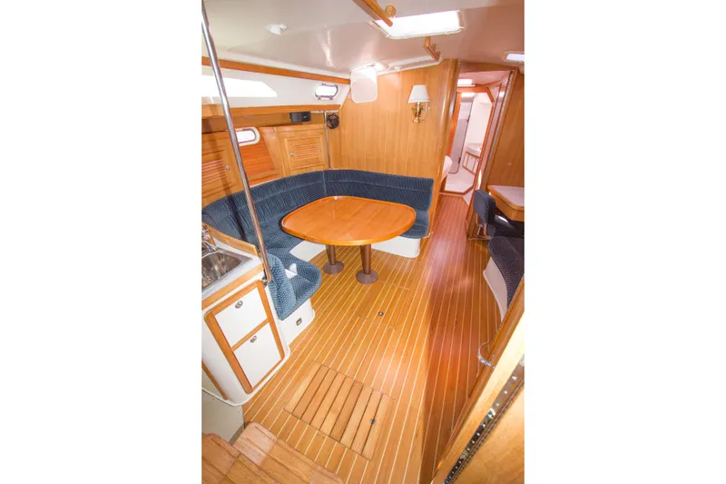 Slide: The Image of Interior of 2008 Catalina 42 MkII sailboat with wooden flooring and cozy seating area. - 10