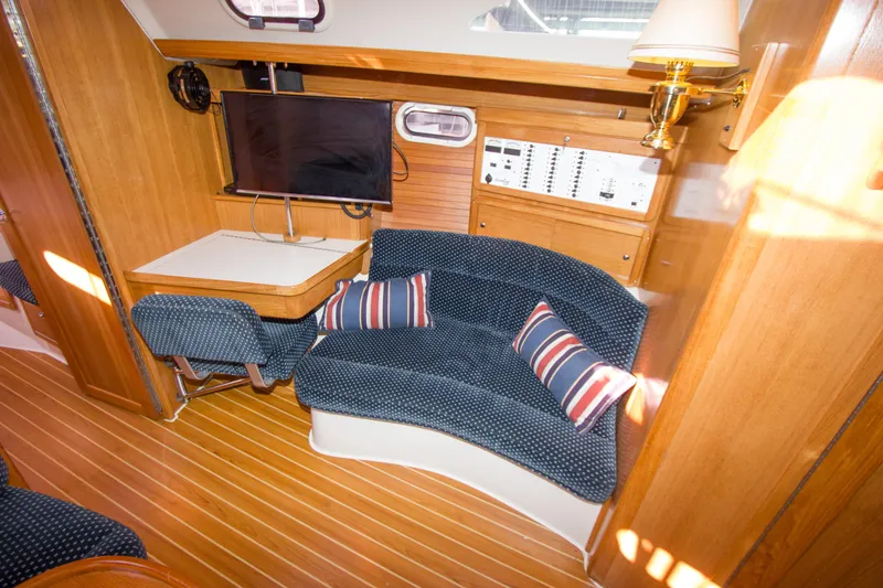 Slide: The Image of Interior of 2008 Catalina 42 MkII yacht with cozy seating and navigation station. - 15