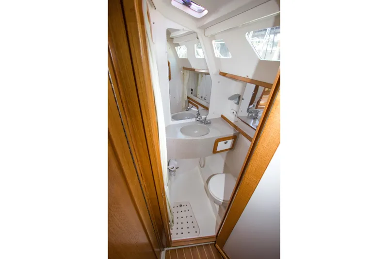 Slide: The Image of 2008 Catalina 42 MkII yacht bathroom with sink, toilet, and wooden accents. - 26