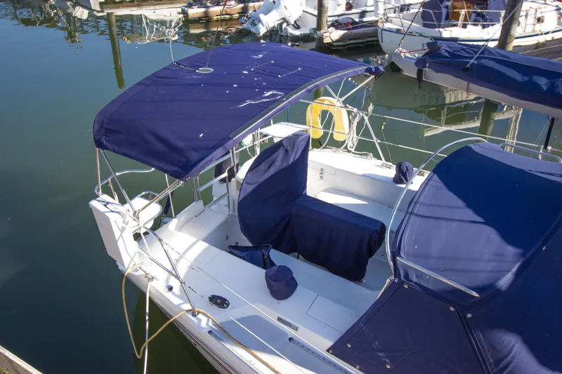Slide: The Image of 2008 Catalina 42 MkII sailboat with blue canvas covers docked at marina. - 30